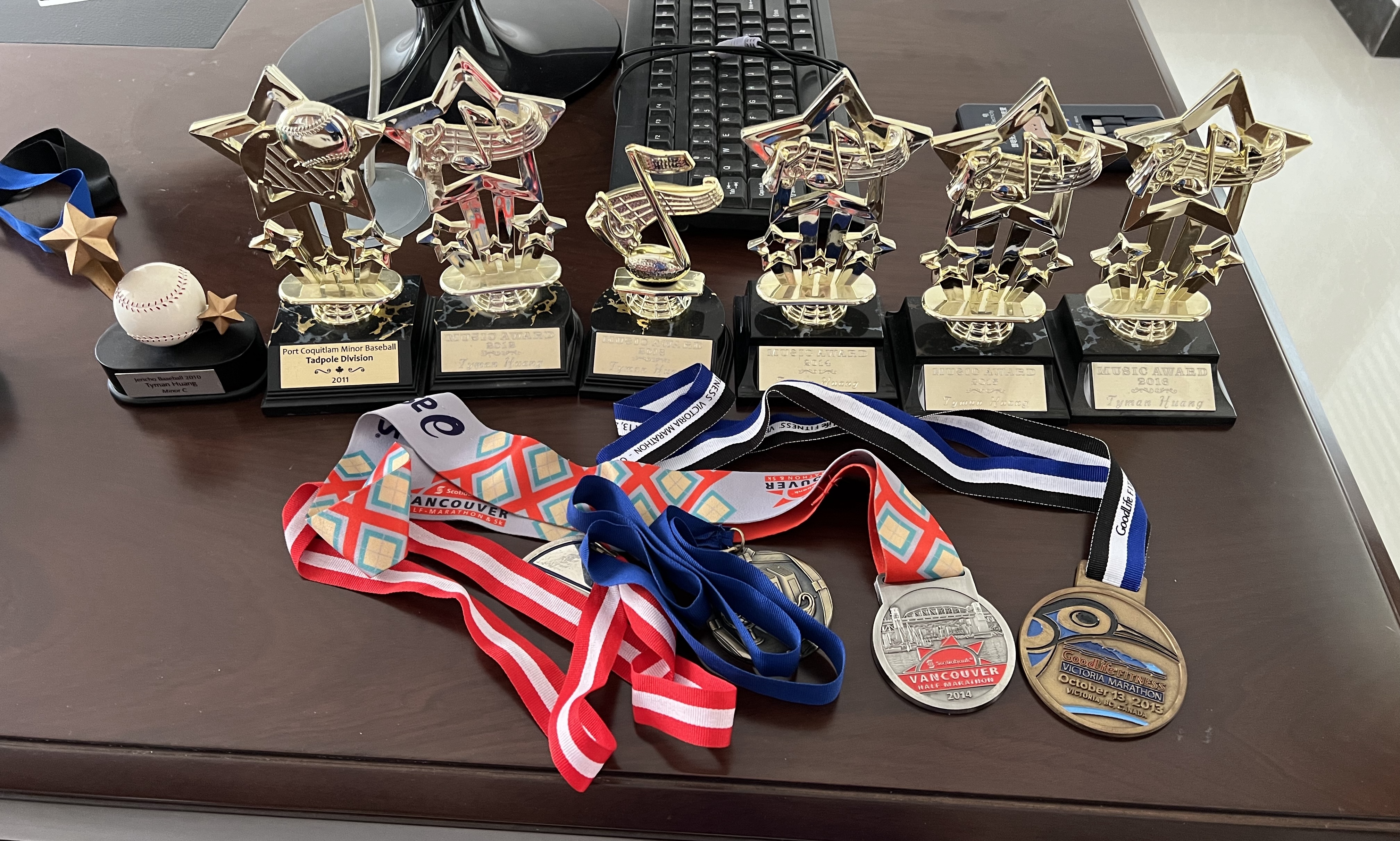 Trophies and medals on a wooden desk
